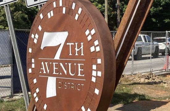 new 7th avenue sign with iron structure looking like railroad tracks