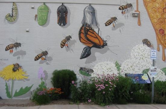 A wall mural showing bees and butterflies.