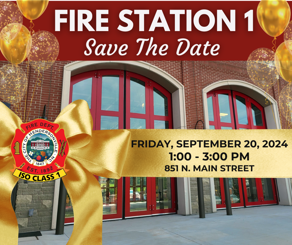 fire station doors with a gold ribon across with text about the grand opening