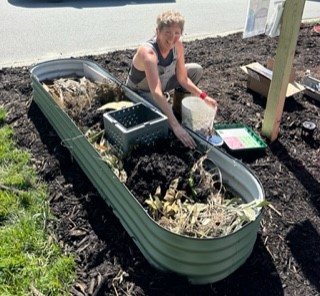 Board member setting up pollinator bed