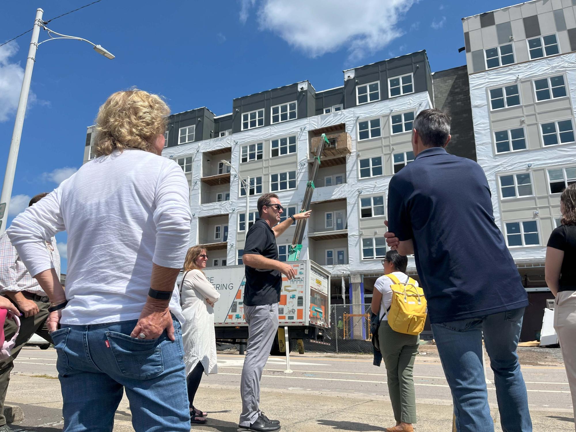 Woman standing outside apartment construction site